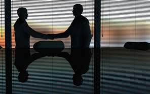 men shaking hands in office